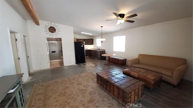 living room featuring lofted ceiling with beams, concrete flooring, and ceiling fan with notable chandelier