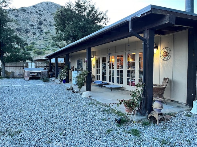 back of house featuring french doors, a patio, and fence