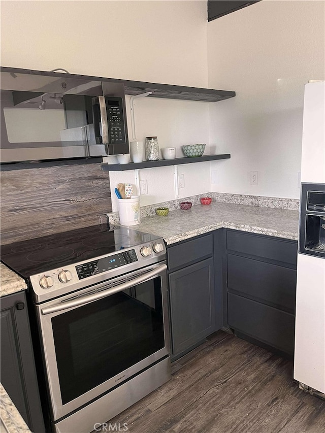 kitchen with dark wood finished floors, light countertops, gray cabinets, appliances with stainless steel finishes, and open shelves