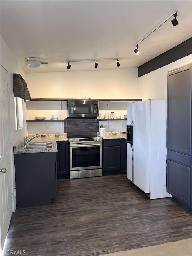 kitchen with dark wood-style floors, a sink, stainless steel appliances, and open shelves