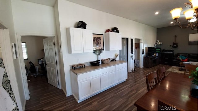 kitchen featuring an inviting chandelier, dark wood-style floors, light countertops, and white cabinetry
