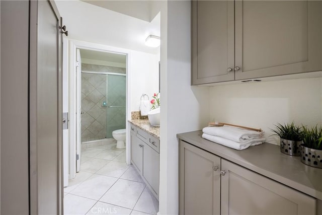 7320 Hawthorn Ave Unit 111, Los Angeles, CA 90046 - full bathroom featuring toilet, vanity, a shower stall, and tile patterned flooring