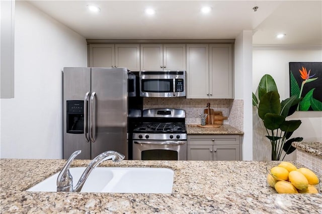 7320 Hawthorn Ave Unit 111, Los Angeles, CA 90046 - kitchen featuring stainless steel appliances, decorative backsplash, gray cabinetry, and recessed lighting