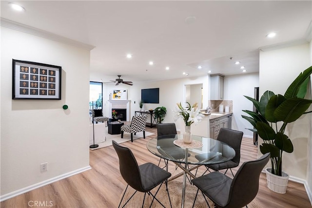 7320 Hawthorn Ave Unit 111, Los Angeles, CA 90046 - dining room with light wood-style flooring, ornamental molding, recessed lighting, ceiling fan, and baseboards