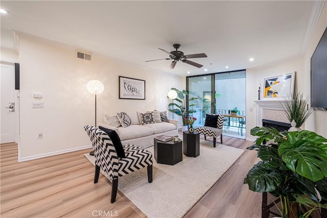 7320 Hawthorn Ave Unit 111, Los Angeles, CA 90046 - living area with crown molding, light wood-style floors, ceiling fan, a tile fireplace, and recessed lighting