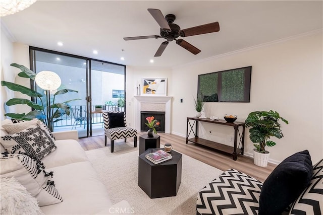 7320 Hawthorn Ave Unit 111, Los Angeles, CA 90046 - living area featuring light wood finished floors, expansive windows, ceiling fan, ornamental molding, and recessed lighting