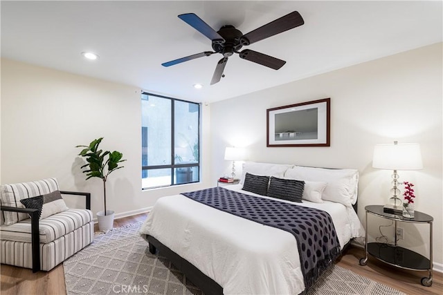 7320 Hawthorn Ave Unit 111, Los Angeles, CA 90046 - bedroom featuring wood finished floors, recessed lighting, baseboards, and a ceiling fan