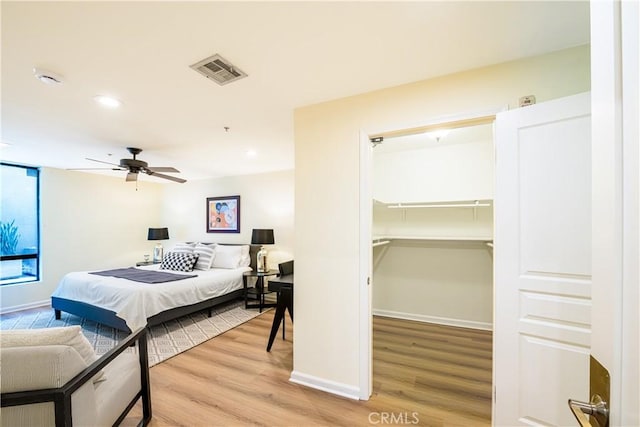 7320 Hawthorn Ave Unit 111, Los Angeles, CA 90046 - bedroom with wood finished floors, a walk in closet, baseboards, recessed lighting, and a closet