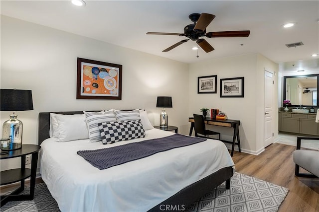 7320 Hawthorn Ave Unit 111, Los Angeles, CA 90046 - bedroom with wood finished floors, recessed lighting, baseboards, connected bathroom, and ceiling fan