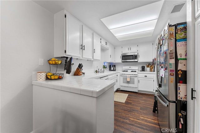 kitchen with visible vents, white cabinets, and appliances with stainless steel finishes