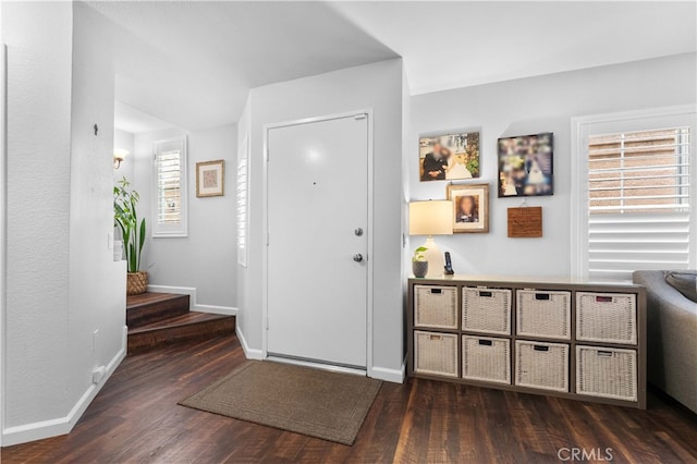 entrance foyer with plenty of natural light, stairs, baseboards, and wood finished floors