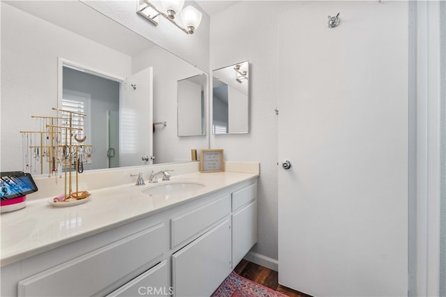 bathroom with wood finished floors and vanity