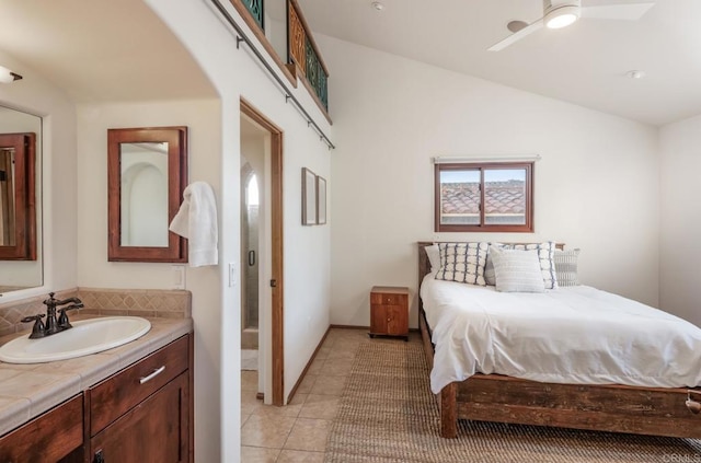 112 La Veta Ave, Encinitas, CA 92024 - bedroom featuring a ceiling fan, arched walkways, vaulted ceiling, a sink, and light tile patterned flooring