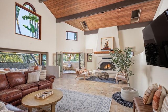 112 La Veta Ave, Encinitas, CA 92024 - living room featuring wood ceiling, a fireplace, beam ceiling, high vaulted ceiling, and stone tile flooring