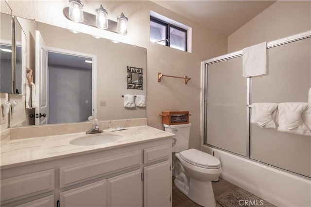 723 Summit Blvd, Big Bear Lake, CA 92315 - full bathroom with toilet, vanity, a textured wall, and combined bath / shower with glass door