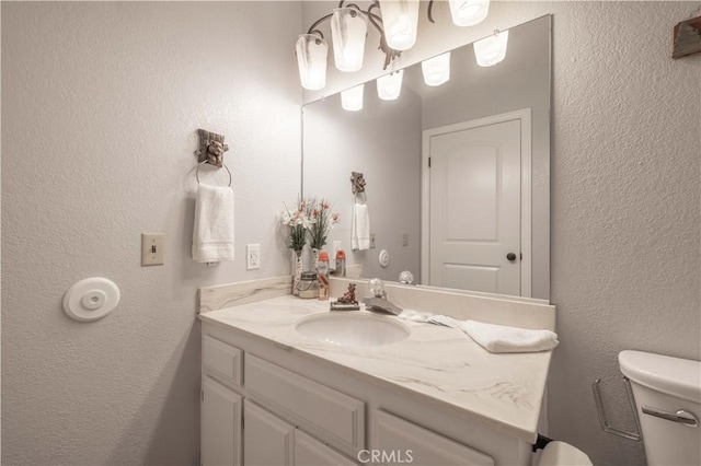 723 Summit Blvd, Big Bear Lake, CA 92315 - half bathroom with a textured wall, vanity, and toilet