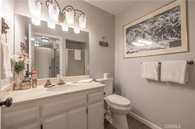 723 Summit Blvd, Big Bear Lake, CA 92315 - full bath featuring baseboards, toilet, vanity, wood finished floors, and a stall shower