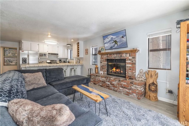 723 Summit Blvd, Big Bear Lake, CA 92315 - living area featuring wood finished floors, a fireplace, and baseboards