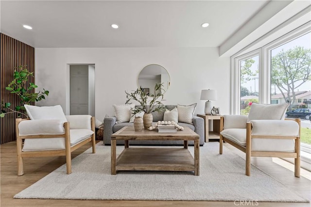 living area with wood finished floors and recessed lighting
