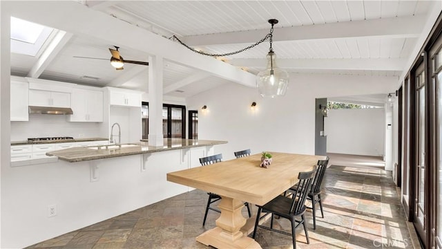 3317 Lees Ave, Long Beach, CA 90808 - dining space with a skylight, dark stone finish floors, wooden ceiling, and a ceiling fan