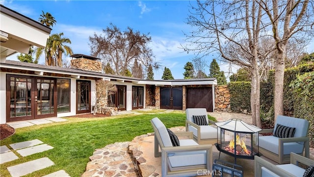 3317 Lees Ave, Long Beach, CA 90808 - view of grassy yard with french doors, a fire pit, and a patio area