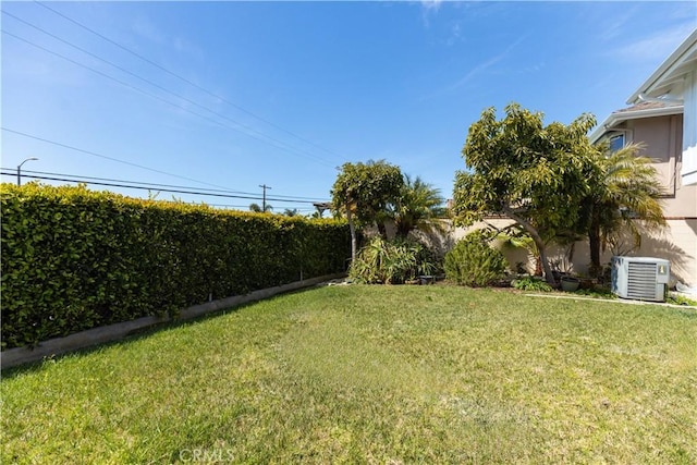 view of yard featuring a fenced backyard and central air condition unit