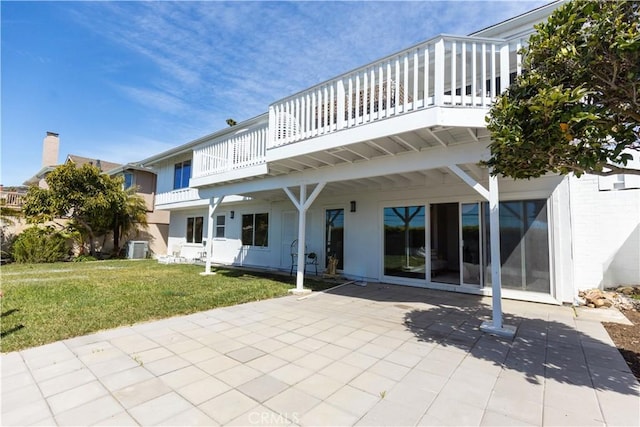 back of property featuring a lawn, central AC unit, and a patio