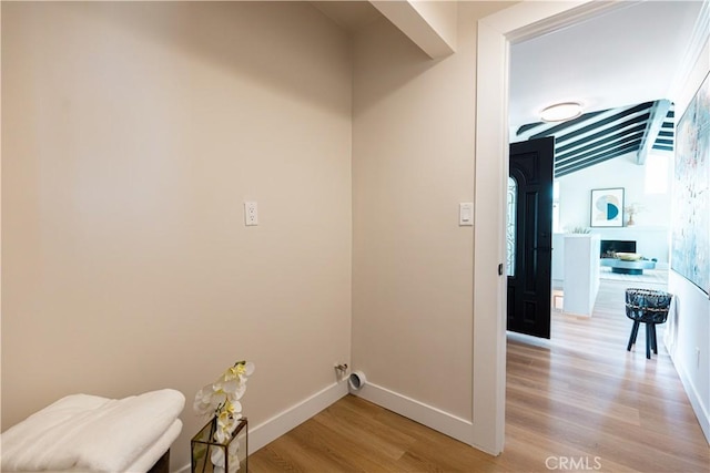 laundry room with baseboards and light wood-type flooring