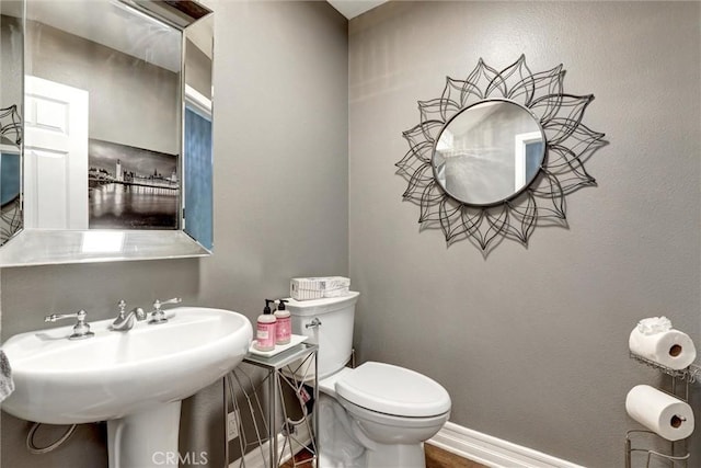 1610 Via Roma Cir, Corona, CA 92881 - half bath featuring a sink, toilet, wood finished floors, and baseboards