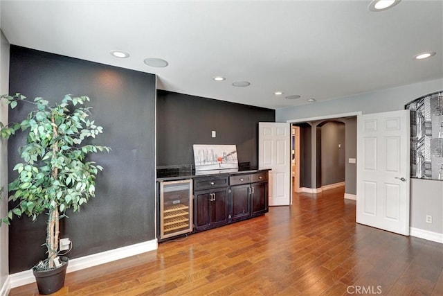 1610 Via Roma Cir, Corona, CA 92881 - bar with beverage cooler, wood finished floors, arched walkways, indoor bar, and baseboards