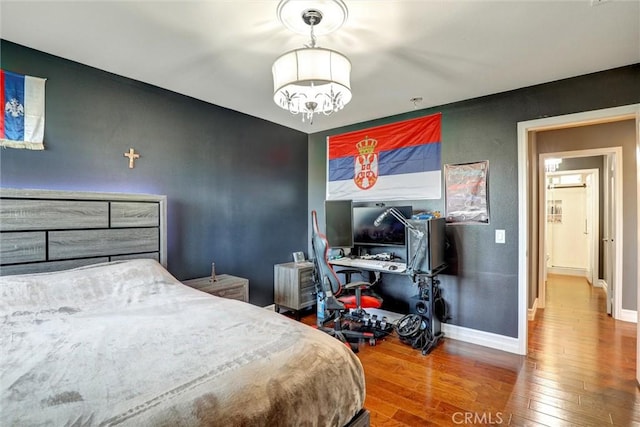 1610 Via Roma Cir, Corona, CA 92881 - bedroom featuring baseboards, a chandelier, and wood-type flooring
