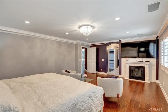 1610 Via Roma Cir, Corona, CA 92881 - bedroom with recessed lighting, wood finished floors, visible vents, arched walkways, and a glass covered fireplace