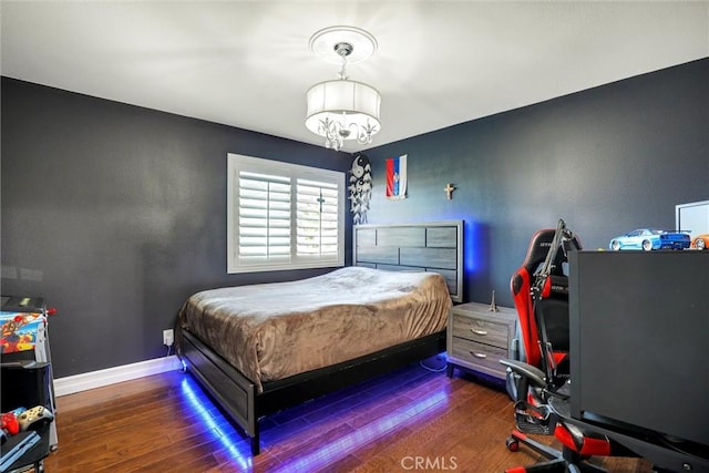 1610 Via Roma Cir, Corona, CA 92881 - bedroom featuring baseboards, wood finished floors, and an inviting chandelier