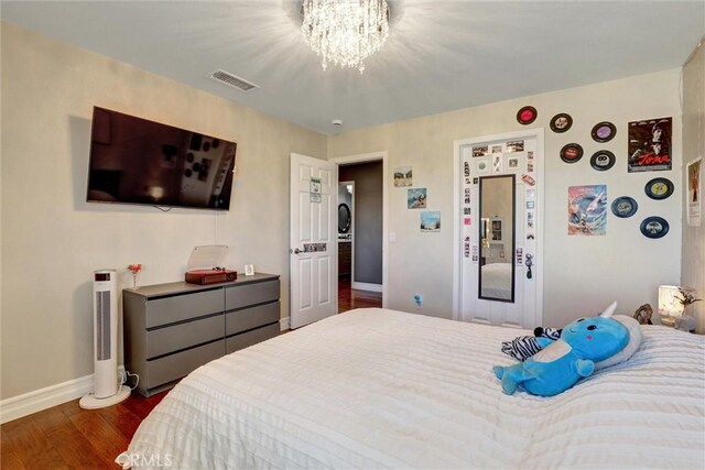 1610 Via Roma Cir, Corona, CA 92881 - bedroom featuring baseboards, a chandelier, dark wood-type flooring, and visible vents