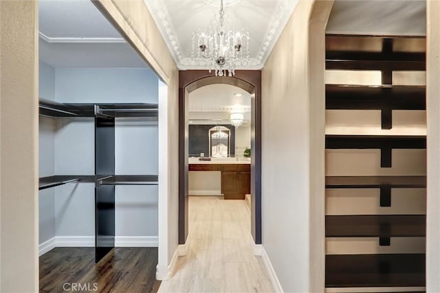 1610 Via Roma Cir, Corona, CA 92881 - corridor featuring ornamental molding, a chandelier, and wood finished floors