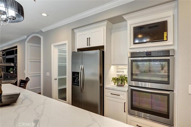 1610 Via Roma Cir, Corona, CA 92881 - kitchen with light stone counters, crown molding, stainless steel appliances, white cabinetry, and recessed lighting