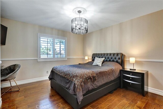 1610 Via Roma Cir, Corona, CA 92881 - bedroom with wood-type flooring, baseboards, and a notable chandelier