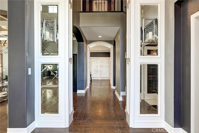 1610 Via Roma Cir, Corona, CA 92881 - corridor with arched walkways, baseboards, and dark wood-type flooring