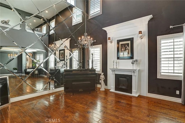 1610 Via Roma Cir, Corona, CA 92881 - living area featuring a high ceiling, a notable chandelier, and wood-type flooring
