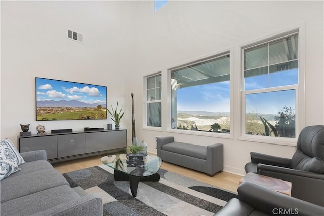 living area featuring wood finished floors and visible vents