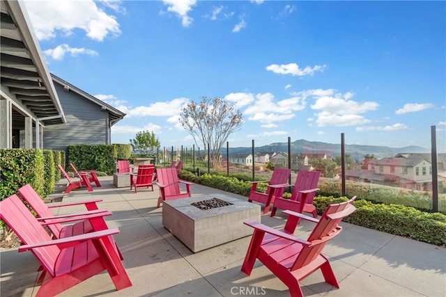 view of patio / terrace featuring an outdoor fire pit and a mountain view