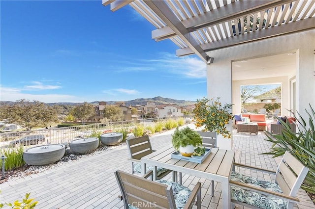 view of patio with outdoor dining area, outdoor lounge area, fence, and a pergola
