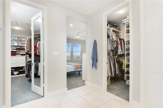 walk in closet with carpet flooring and a ceiling fan