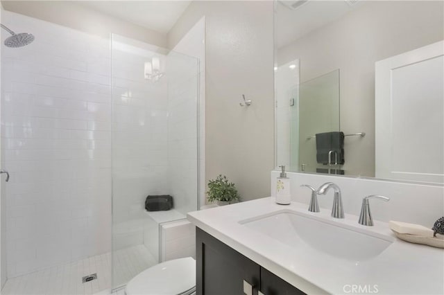bathroom with vanity, toilet, and a stall shower