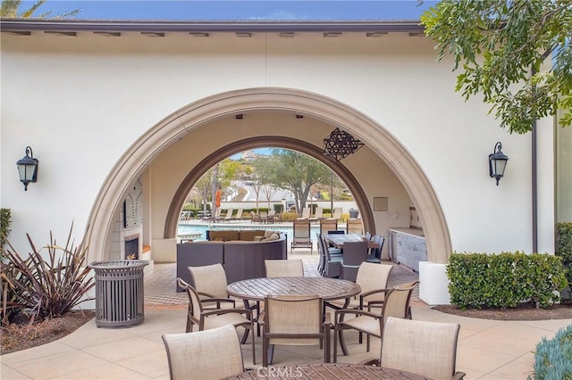 view of patio / terrace featuring a community pool and outdoor dining area
