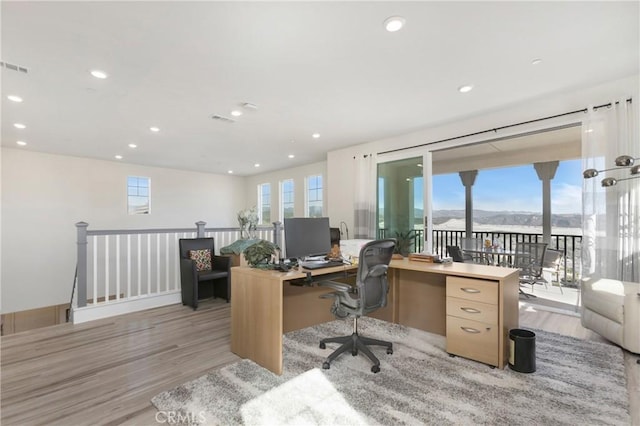 home office featuring recessed lighting, a healthy amount of sunlight, and light wood finished floors