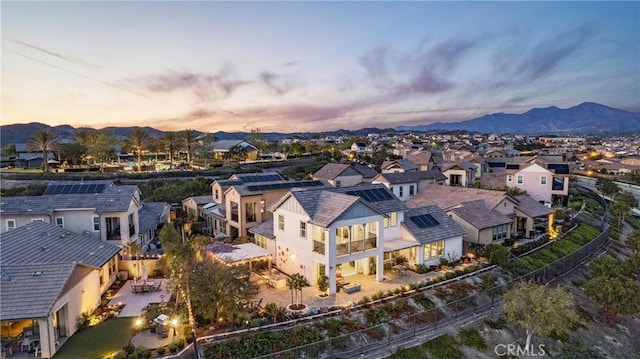aerial view at dusk with a residential view and a mountain view
