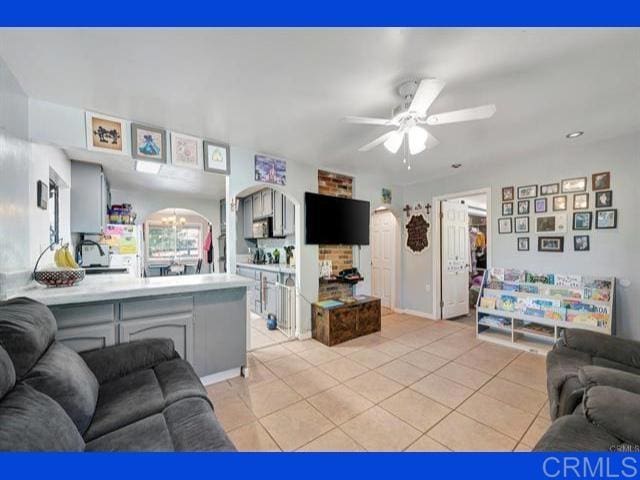 living room featuring light tile patterned floors and ceiling fan