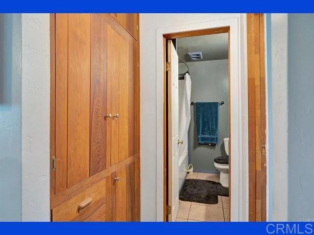 hall with tile patterned flooring