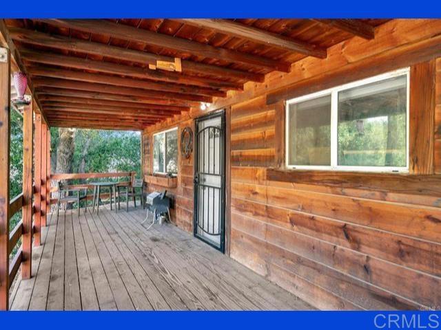 wooden terrace featuring an outbuilding